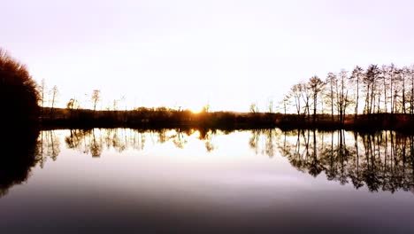 Aerial-flight-over-fishing-lake-in-fall