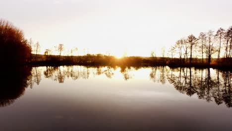 Aerial-flight-over-fishing-lake-in-fall