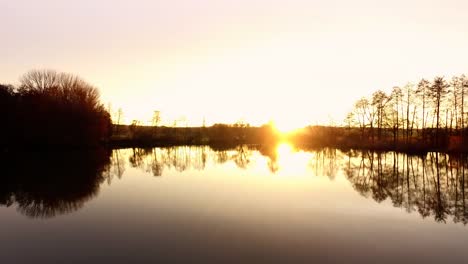 Aerial-flight-over-fishing-lake-in-fall