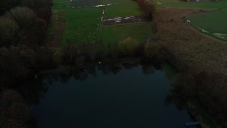 Aerial-flight-over-fishing-lake-in-fall