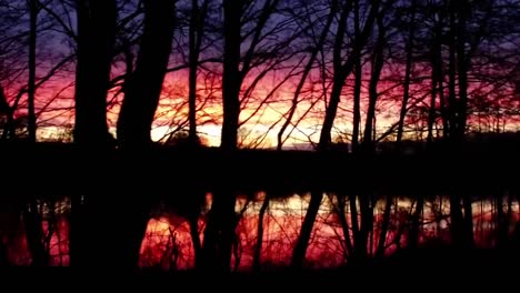 Aerial-flight-over-fishing-lake-in-fall