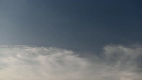 Time-lapse-clip-of-white-clouds-over-blue-sky