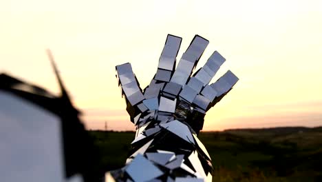 Man-with-mirror-costume-touching-the-sunlight-by-hand