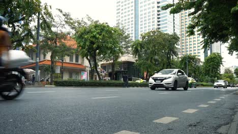 Traffic-street-in-downtown,-cars-moving-by-roadway-at-working-day