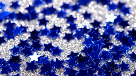 Sparkling-glitter-in-the-shape-of-a-star.-Close-up-on-a-silver-background