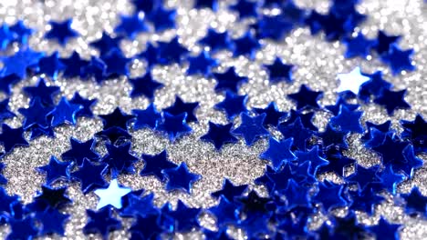 Sparkling-glitter-in-the-shape-of-a-star.-Close-up-on-a-silver-background