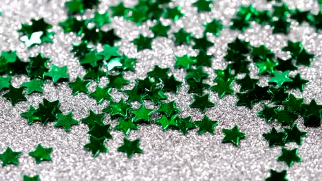 Sparkling-glitter-in-the-shape-of-a-star.-Close-up-on-a-silver-background