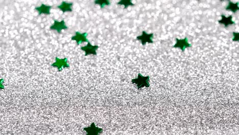 Sparkling-glitter-in-the-shape-of-a-star.-Close-up-on-a-silver-background