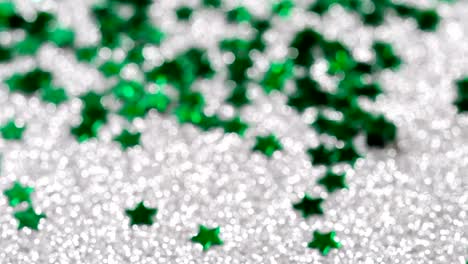 Sparkling-glitter-in-the-shape-of-a-star.-Close-up-on-a-silver-background