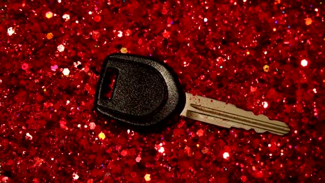 Car-key-against-the-background-of-red-glitter