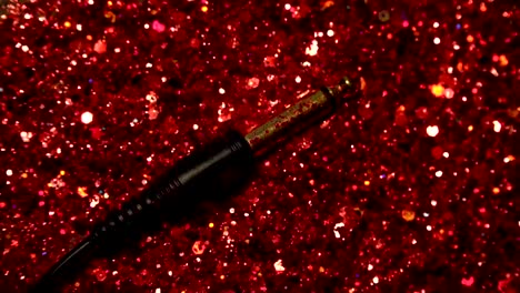 Black-cable-on-the-background-of-red-glitter