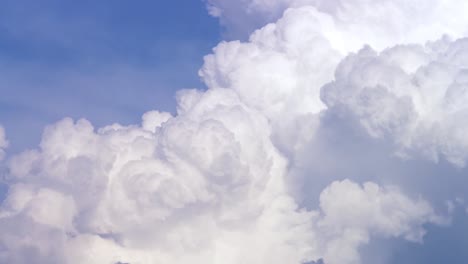 Blue-sky-with-clouds-timelapse.-White-big-cloud-on-blue-sky.-a-big-and-fluffy-cumulonimbus-cloud-in-the-blue-sky.-Edge-of-a-large-white-cloud-timelapse.-panorama.-landscape-blue-sky-moving-timelapse