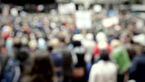 A-large-gathering-of-people-in-a-downtown-city