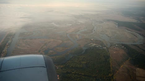 Lanscape-seen-through-the-window-of-jet-airplane-in-bright-sunny-day.-View-in-motion.-HD-video-High-Definition