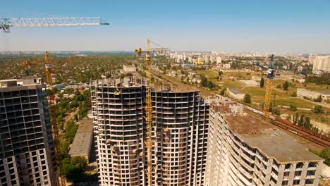 Construction-of-houses.-Drone-fly-over-construction-site-with-tower-cranes