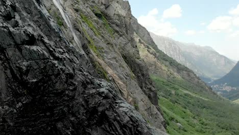 Tracking-and-top-shot-Air-shot-from-a-stream-of-water-splashing-waterfall-on-a-rock-wall-in-the-Caucasus-Mountains.-Around-the-jet-of-the-waterfall