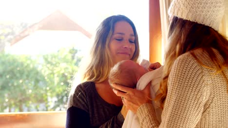 Lesbian-couple-holding-their-baby-boy-4k