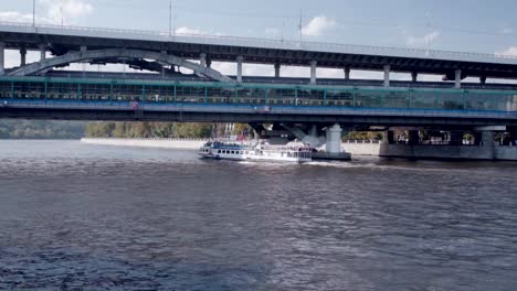 Pleasure-boat-passes-under-the-bridge-on-a-sunny-day