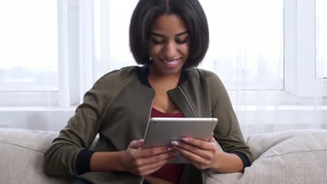 Teenage-girl-using-digital-tablet-at-home