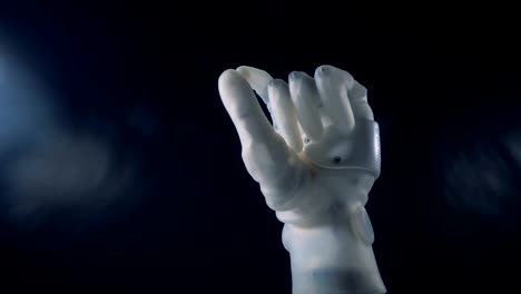 White-bionic-hand-moving.-Metal-prosthetic-hand-working.