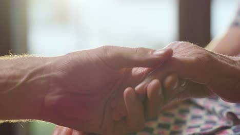 young-person-helps-her-grandmother-to-get-up-taking-her-hands.