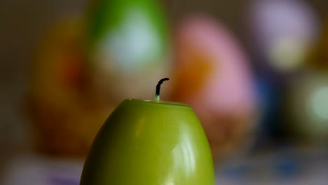 Candles-made-in-shape-of-easter-egg.-Burning-candles.-Green-candles-extinguished-from-the-air.