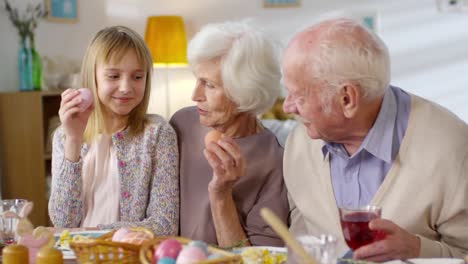 Girl-Playing-with-Grandparents-at-Easter-Dinner