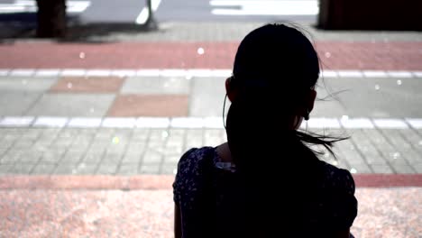 Silhouette-of-a-little-girl-sitting-at-the-bus-stop.