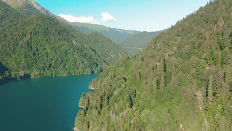 Mountain-lake-with-turquoise-water-and-green-tree