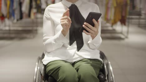 Unrecognizable-Woman-in-Wheelchair-Browsing-Internet-on-Phon