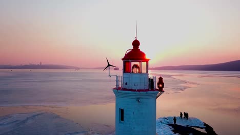 Aerial-winter-view-of-the-Tokarevskiy-lighthouse---one-of-the-oldest-lighthouses-in-the-Far-East,-still-an-important-navigational-structure-and-popular-attractions-of-Vladivostok-city,-Russia.