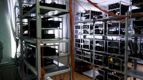 Cryptocurrency-equipment,-mining-money-electronic-farm,-finance-concept.-Stock-footage.-Bitcoin-farm-with-working-computer-equipment