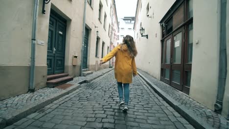 Female-tourist-is-happily-walking-along-the-paved-road