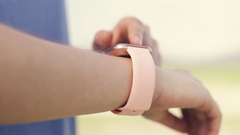 Close-up-authentic-athlete-tracking-fitness-progress-on-her-smartwatch-after-running-workout.-Female-runner-using-fitness-app-to-checking-heart-rate-monitor.Athlete-sport-running-workout-concept.