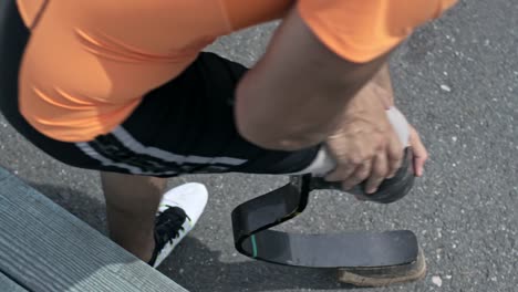 Top-View-of-handicapped-Sportsman-Putting-on-Running-Blade