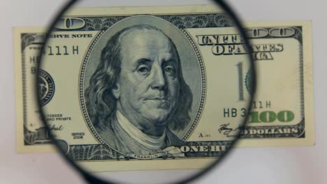 Approaching-using-a-magnifying-glass-hundred-dollar-bill