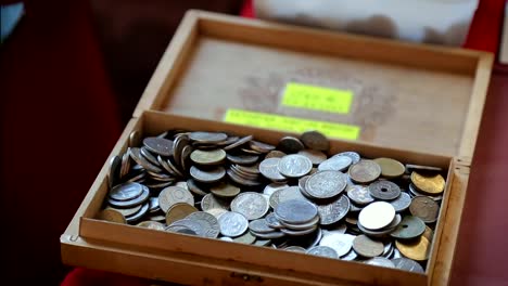 Big-collection-of-retro-coins-piled-up-in-old-treasure-box,-numismatics,-hobby