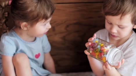 children-watching-a-candy-jar