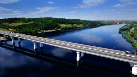 AERIAL-Fly-over-traffic-bridge-highway-roadway-road-way-and-blue-river-with-trees-forest,-Europe,-Russia,-Tatarstan