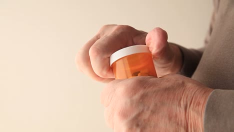 Man-with-tremor-tries-to-open-pills