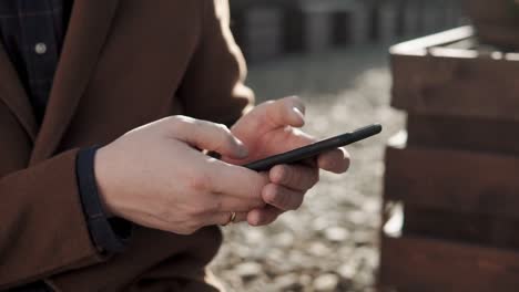 close-up-shot-of-a-man's-hands,-who-dials-a-phone-number-to-call-a-friend