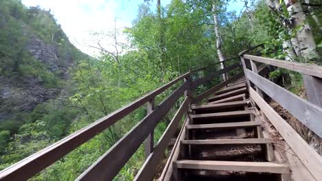 A-man-is-walking-up-the-stairs-of-the-mountains.