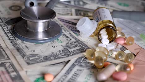 medical,-treatment-expenses,-concept,-pills-on-money,-dollars,-rotating,-turning