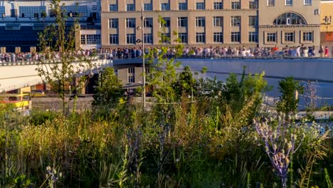 tourists-walk-and-take-photos-on-the-pedestrian-bridge-with-a-good-vantage-point,-time-lapse