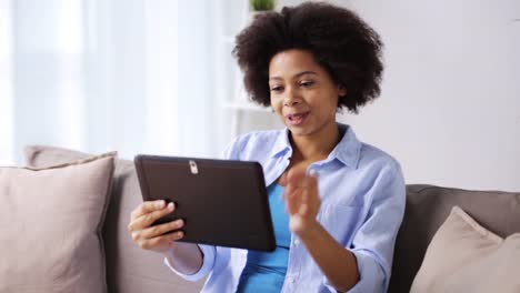 happy-afro-american-woman-with-tablet-pc-at-home