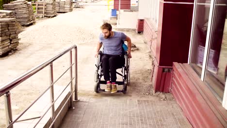 A-disabled-man-in-a-wheelchair-rising-up-to-the-slope