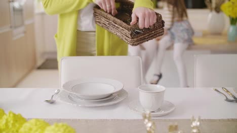 Unrecognizable-woman-setting-the-table