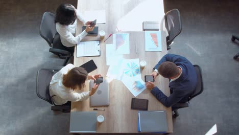 workers-in-startup-company-sitting-in-boardroom