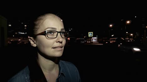 Portrait-of-young-beautiful-caucasian-woman-using-smart-phone-hand-hold-outdoor-in-the-city-night,-smiling,-face-illuminated-screenlight---social-network,-technology,-comunication-concept