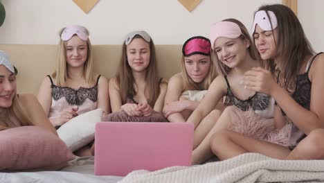 Teen-girls-having-fun-watching-media-content-on-laptop